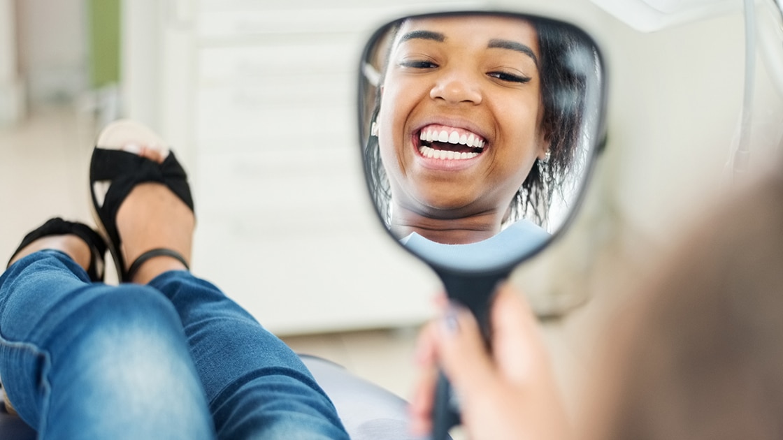 Smilng Girl in Mirror with Aligners